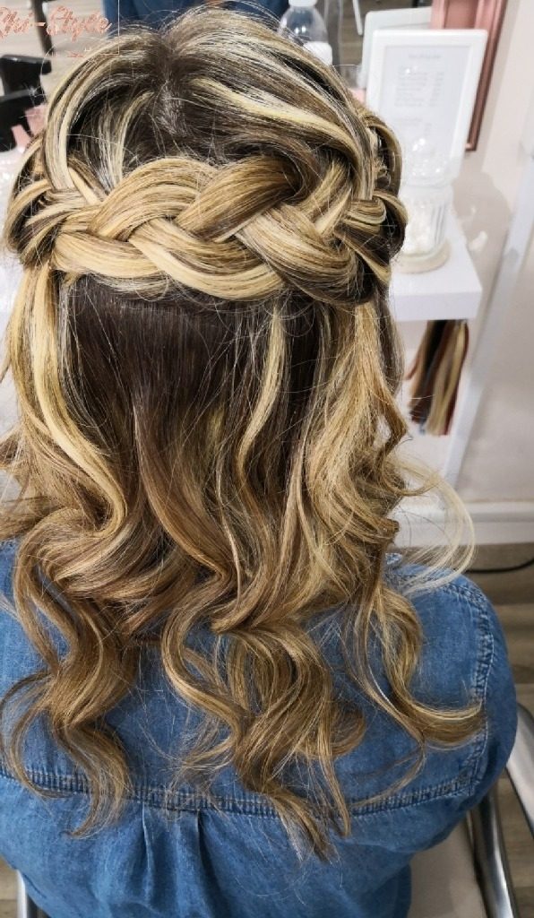 A braided half-up style with soft curls